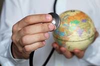 Doctor with stethoscope and globe in his hand. Medical network a